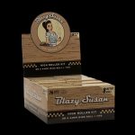 A box of “Blazy Susan” High Roller Kit rolling papers, featuring a vintage-style illustration of a woman and text indicating 8-meter rolls and included tips.