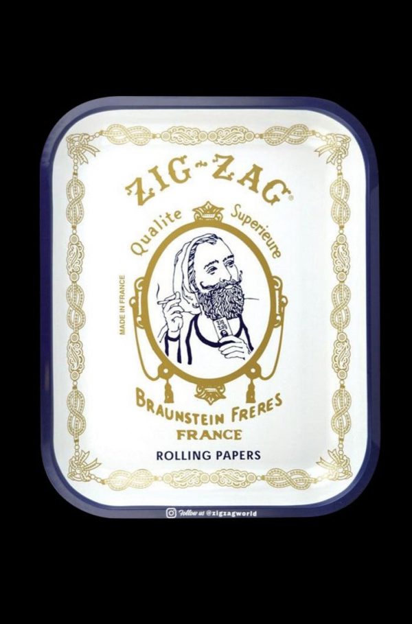 Overhead view of the Large Zig Zag Original Rolling Tray displaying vintage branding on a patterned surface.