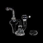 Glass water pipe (rig) with accompanying glass bowl, isolated on a black background.