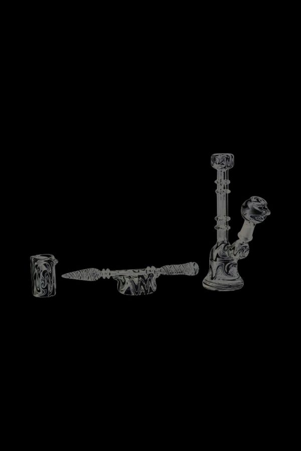 A close-up shot of the Glass Bell Dab Rig, showcasing the clear glass construction and angled mouthpiece from a low perspective.