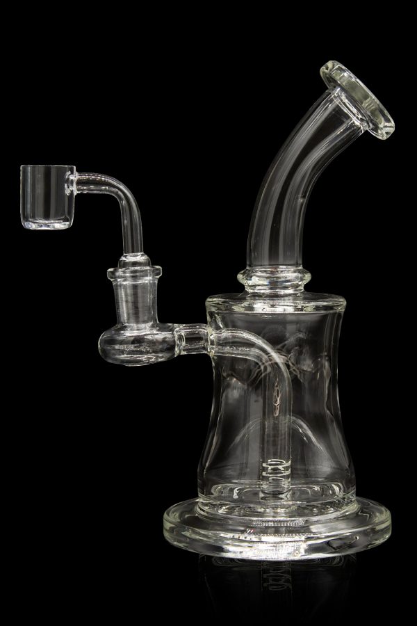 Clear glass dab rig with quartz banger, against a black background.