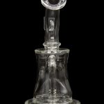Clear glass dab rig with intricate design, isolated on black.