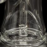 Clear glass dab rig with swirling vapor, showcasing intricate glasswork.