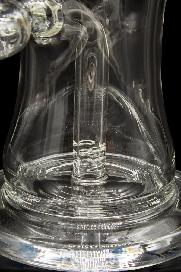 Clear glass dab rig with swirling vapor, showcasing intricate glasswork.
