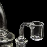 Clear glass dab rig with a quartz insert.