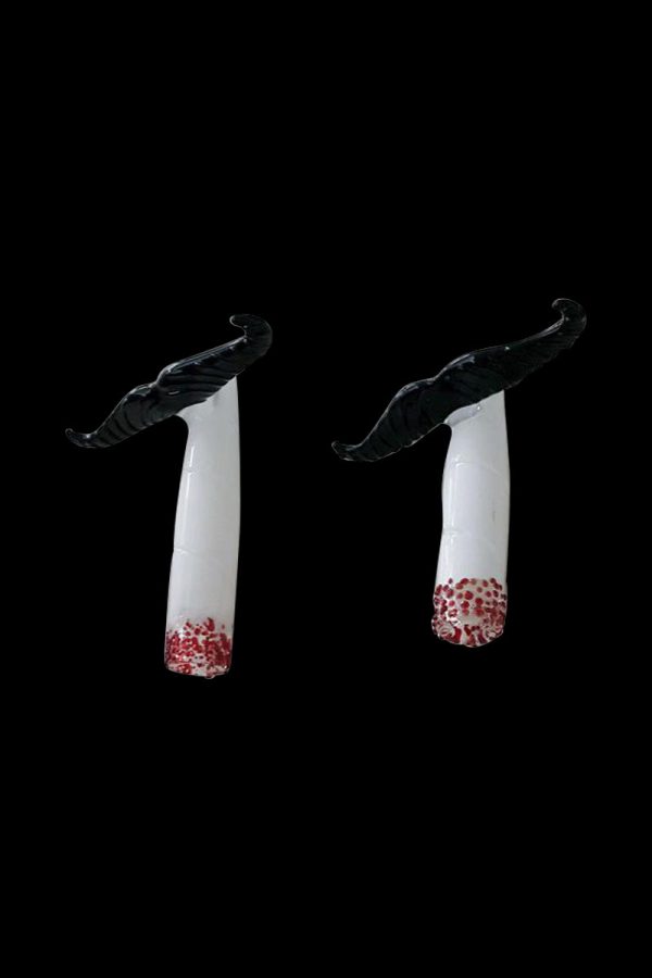 A studio shot of the Mustache Cig One Hitter, showcasing its clean lines and minimalist design against a stark black background.