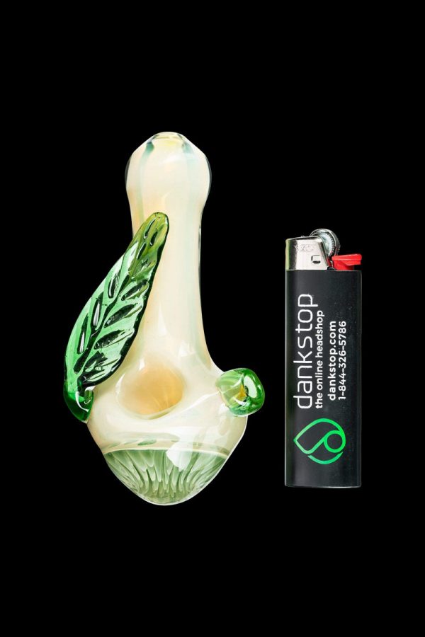 A close-up of the Leafy Green Mushroom Milli Spoon Pipe shows a green, mushroom-shaped glass pipe against a black background.