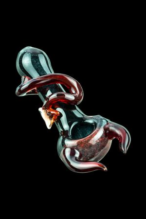A close-up, angled view of the Little Devil Hand Pipe, showcasing its glossy, dark red finish and curved design.