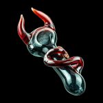 A close-up angled view of the Little Devil Hand Pipe, showcasing the sculpted, dark-colored glass design.