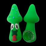 Green silicone cannabis pipes shaped like Christmas trees, one with a cartoon face.