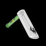 Glass pipe with green mouthpiece and black raven graphic, isolated on a black background.