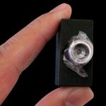 A close-up shows the Aurora Halo Ceramic Quartz Atomizer held against a dark background, highlighting its small size.