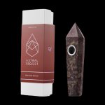 Astral Project Dragons Blood gemstone pipe in its packaging, isolated on a black background.