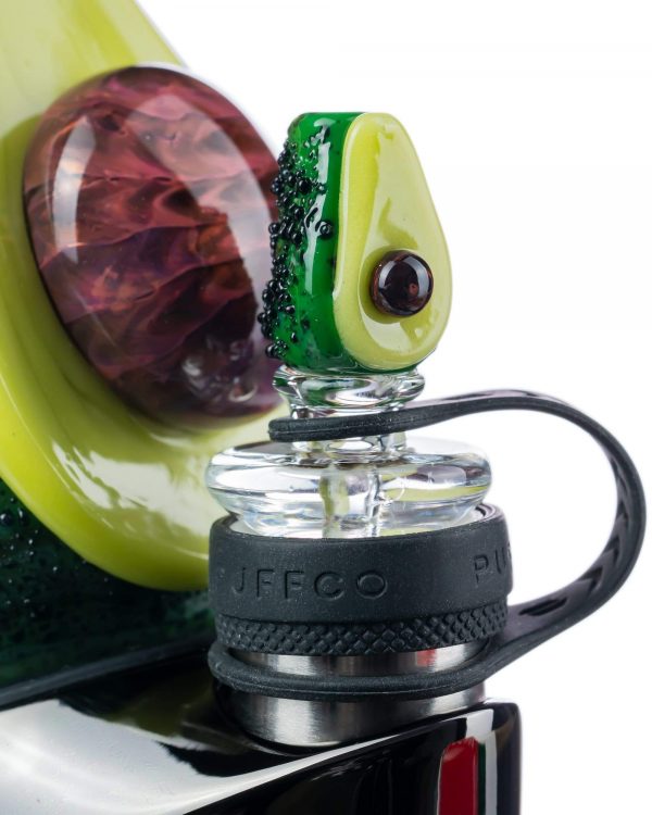 Close-up view of the Empire Glassworks Avocadope Carb Cap for Puffco Peak, showcasing its green, sculpted design against a blurred background.