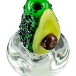 The Empire Glassworks Avocadope Carb Cap for Puffco Peak is shown in a close-up, highlighting its green, avocado-shaped design.