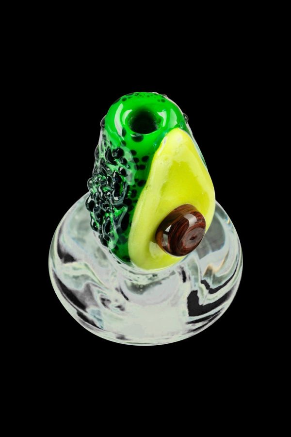 A close-up, angled view of the Empire Glassworks Avocadope Carb Cap for Puffco Peak, showcasing its sculpted green glass design.