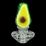 A close-up, angled view of the Empire Glassworks Avocadope Carb Cap for Puffco Peak, displaying its detailed, green avocado-shaped design.