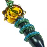 A close-up view of the Empire Glassworks Dragon Sphere Small Spoon Pipe, displaying a colorful glass design.