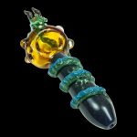 A close-up, angled view of the Empire Glassworks Dragon Sphere Small Spoon Pipe, showcasing its colorful, sculpted glass design.