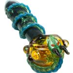 A close-up angled view of the Empire Glassworks Dragon Sphere Small Spoon Pipe, featuring a textured, colorful glass design.