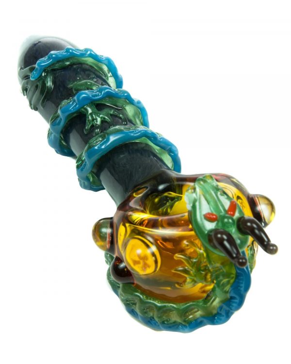 A close-up angled view of the Empire Glassworks Dragon Sphere Small Spoon Pipe, featuring a textured, colorful glass design.