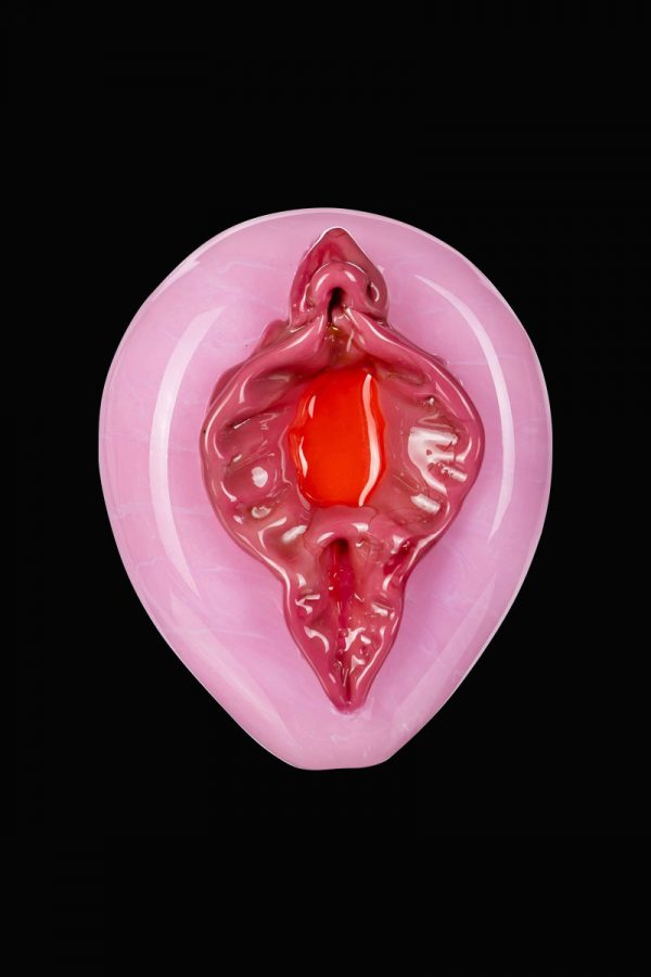 A close-up, angled view of the Empire Glassworks "Pink Panther" hand pipe, showcasing its pink, sculpted glass design.