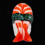 Front view of the Empire Glassworks Shrimp Nigiri Sushi Hand Pipe, a vibrant red glass sculpture resembling sushi.