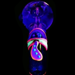 Glow-in-the-dark glass pipe shaped like a mushroom against a black background.