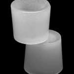 Frosted glass joint tips stacked on a black background.