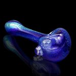 Blue glass cannabis pipe with iridescent sheen, reflecting on a dark surface.