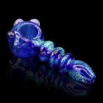 Blue glass cannabis pipe with speckled detailing on a reflective surface.