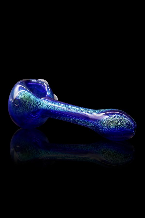 Blue glass pipe with glitter flecks, reflecting on a dark surface.