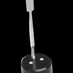 Silver dab tool resting in a black base with two small indentations.