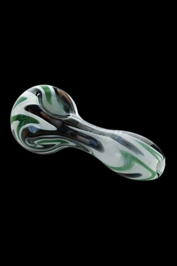 Glass pipe with swirling green and white patterns on a black background.