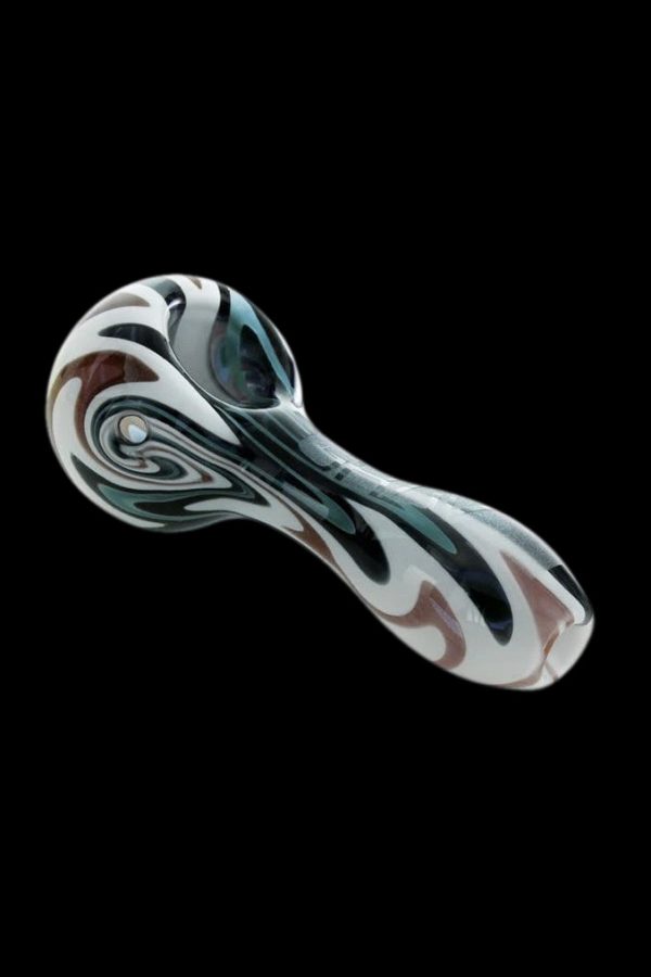 Glass pipe with swirling black, white, and brown patterns against a black background.