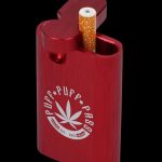 An Aluminum Dugout is shown in a close-up, angled view with a partially smoked joint inserted into its open slot.