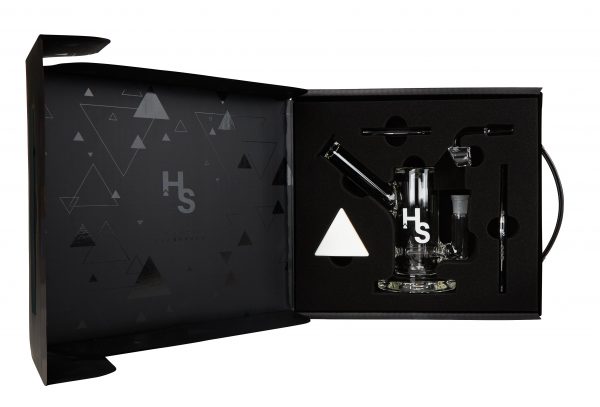 A studio shot displays the Higher Standards Heavy Duty Rig against a dark background with subtle triangular patterns.