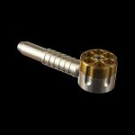 Gold-colored metal oil burner pipe for cannabis concentrates on a black background.