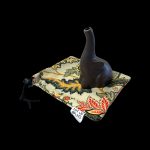 Dark brown oil lamp pipe rests inside a patterned drawstring bag with “Art of Smoke” printed on it.
