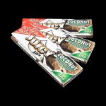 A close-up, angled shot of Juicy Jay's Classic Size Flavored Rolling Papers package with bright colors and bold branding.