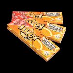 A close-up of Juicy Jay's Classic Size Flavored Rolling Papers package with orange coloring angled towards the viewer.
