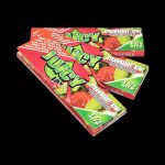 A close-up, slightly angled view of Juicy Jay's Classic Size Flavored Rolling Papers, showing a stack of colorful patterned papers.