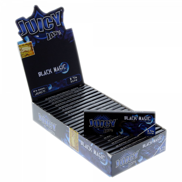 A close-up of Juicy Jay's 1 1/4 Black Magic Rolling Papers packaging, with the black pack angled slightly toward the viewer.