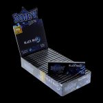 A close-up of the Juicy Jay's 1 1/4 Black Magic Rolling Papers package, angled slightly to showcase the branding and black color scheme.