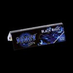 A close-up of the black packaging for Juicy Jay's 1 1/4 Black Magic Rolling Papers, displaying bold lettering and branding details.