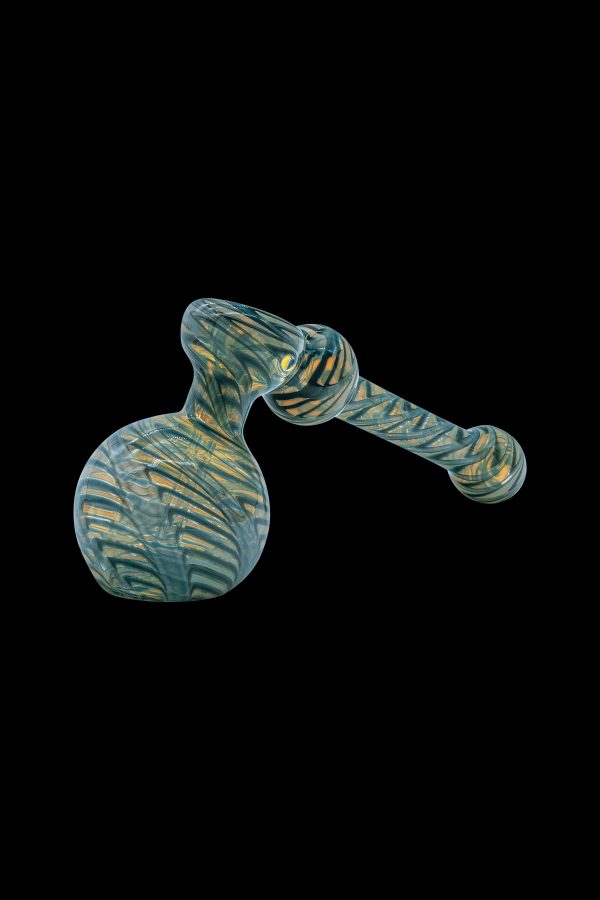 Green and gold glass bubbler pipe against a black background.