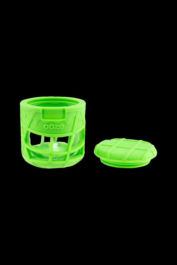 Neon green silicone cannabis concentrate container with a textured, geometric design and removable lid.