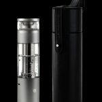 Silver and black cannabis e-rig with a carrying case, studio shot on a black background.