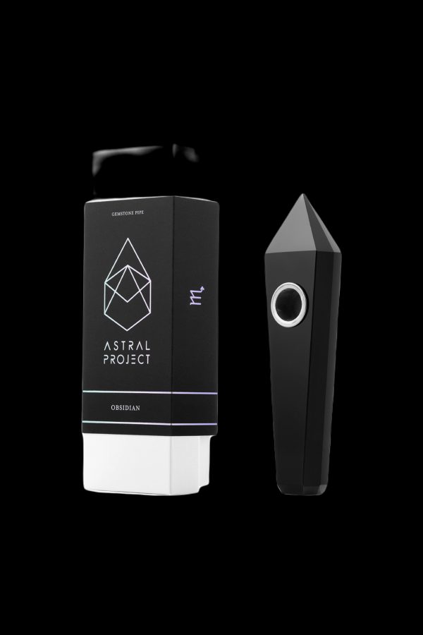 Black and white packaging for “Astral Project” obsidian gemstone pipe with a geometric design and the pipe itself, isolated on a black background.
