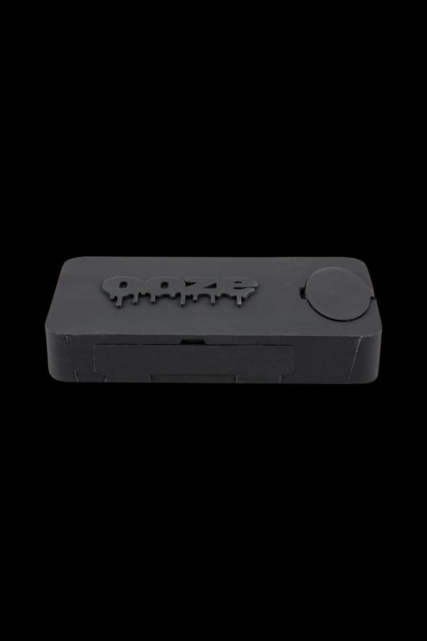 A close-up, angled view of the Ooze Slugger Dabbin Dugout, showcasing its sleek, dark design and compact size.